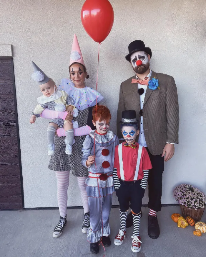 Family in vintage clown costumes with striped tights and face paint