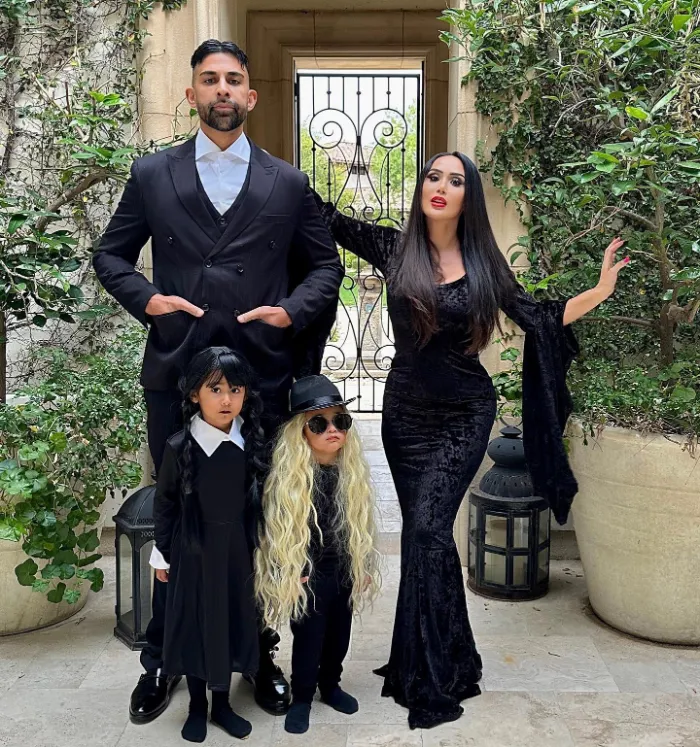 Family dressed as Morticia, Gomez, Wednesday, and Cousin Itt