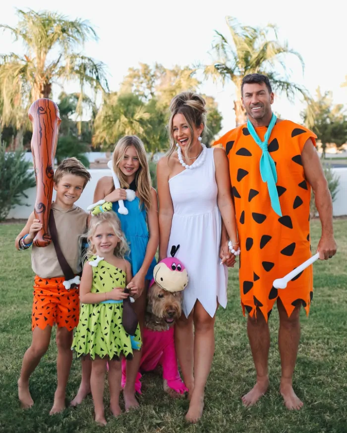 Family dressed as Fred, Wilma, Pebbles, and friends from The Flintstones