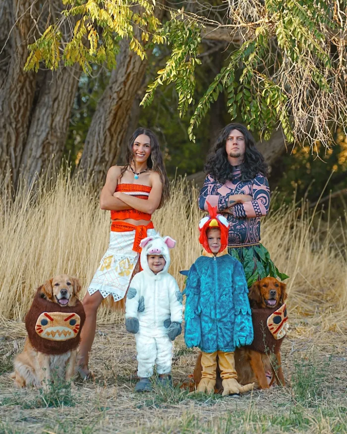 Family dressed as Moana, Maui, and kids as Pua and Hei Hei with pets in costumes