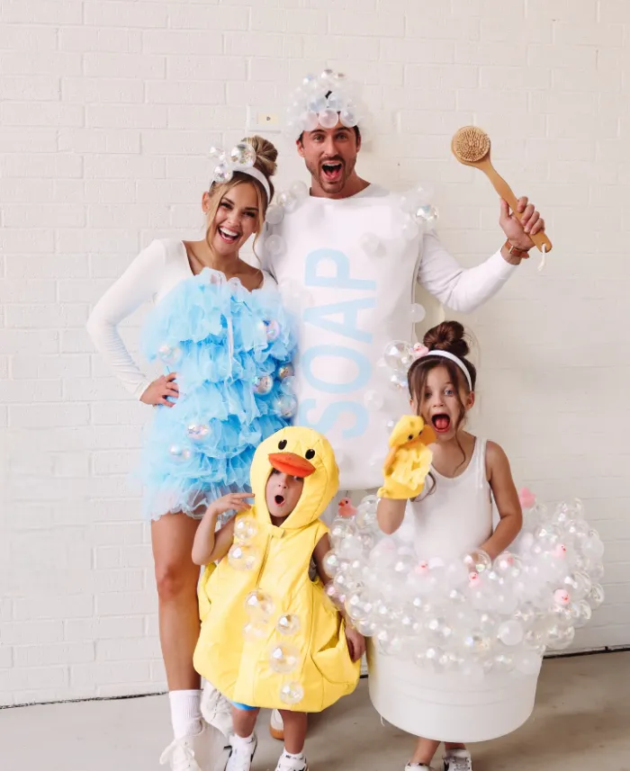 Family costumes as soap, bubbles, a rubber duck, and a loofah.